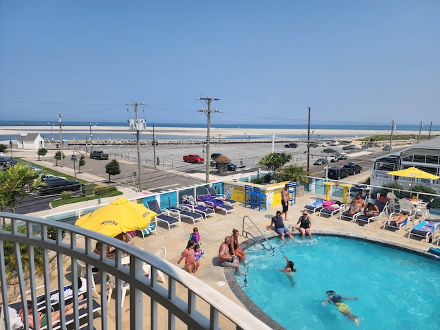 view of pool featuring a water view