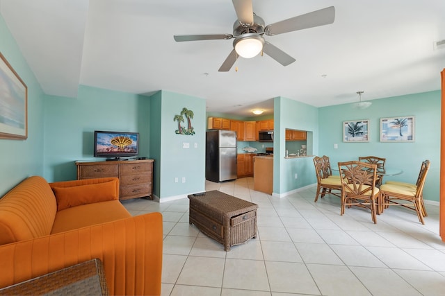 living room featuring light tile patterned floors and ceiling fan