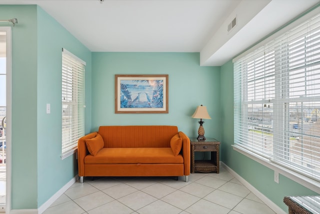 living area with plenty of natural light and light tile patterned flooring