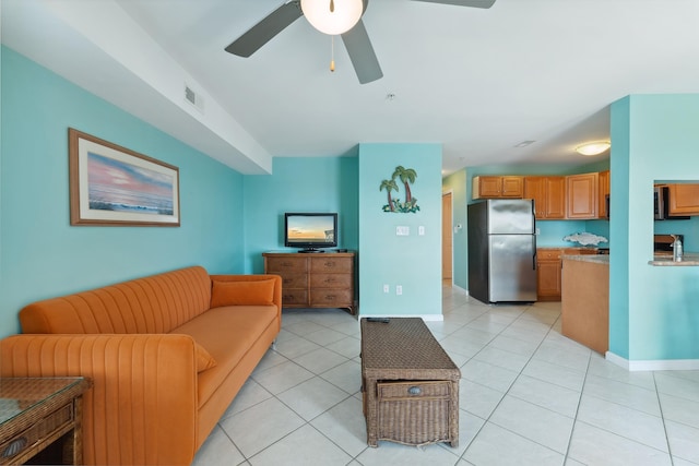 tiled living room featuring ceiling fan