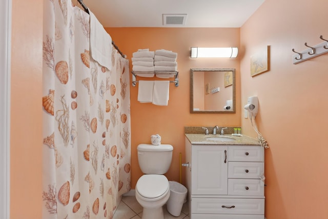 bathroom with walk in shower, tile patterned flooring, vanity, and toilet