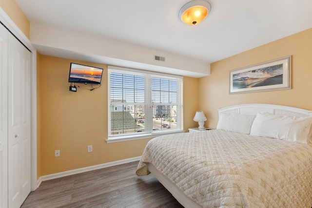 bedroom with a closet and hardwood / wood-style floors