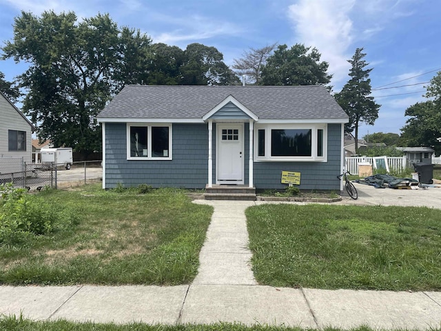 bungalow-style home featuring a front yard