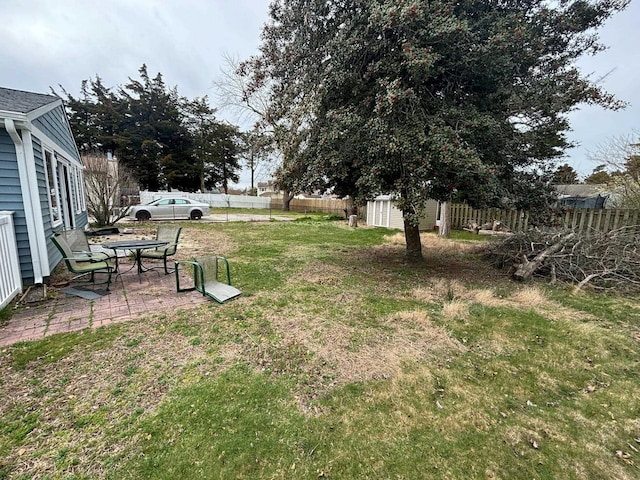 view of yard with a storage unit and a patio area