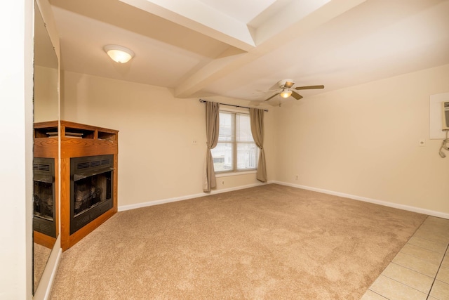 unfurnished living room featuring ceiling fan, beam ceiling, and light tile patterned flooring