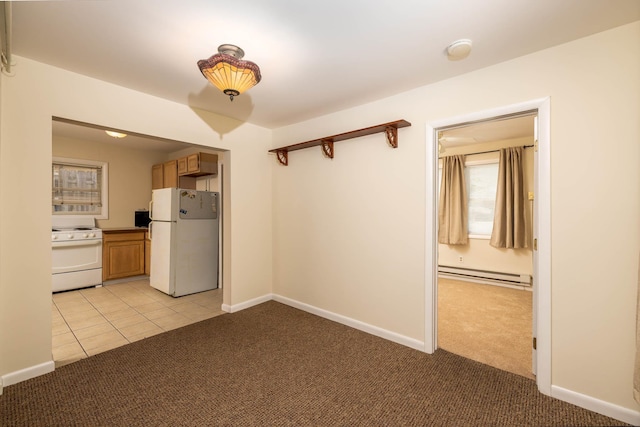 interior space with light colored carpet, white appliances, and a baseboard heating unit