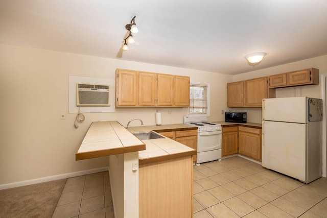 kitchen featuring kitchen peninsula, white appliances, sink, light tile patterned floors, and an AC wall unit