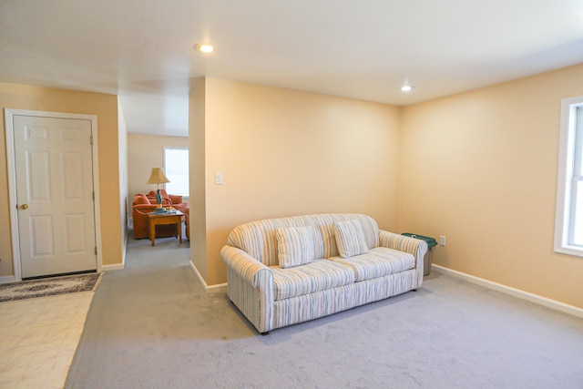 carpeted living area featuring baseboards, recessed lighting, and plenty of natural light