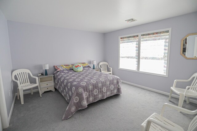 carpeted bedroom featuring baseboards