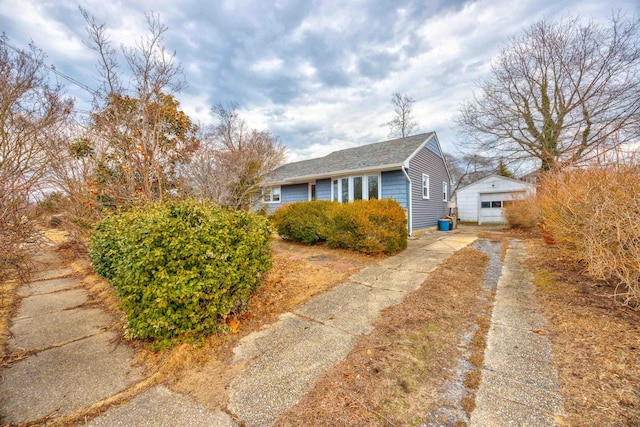 view of property exterior featuring a garage and concrete driveway