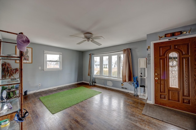 entryway with visible vents, ceiling fan, baseboards, and wood finished floors