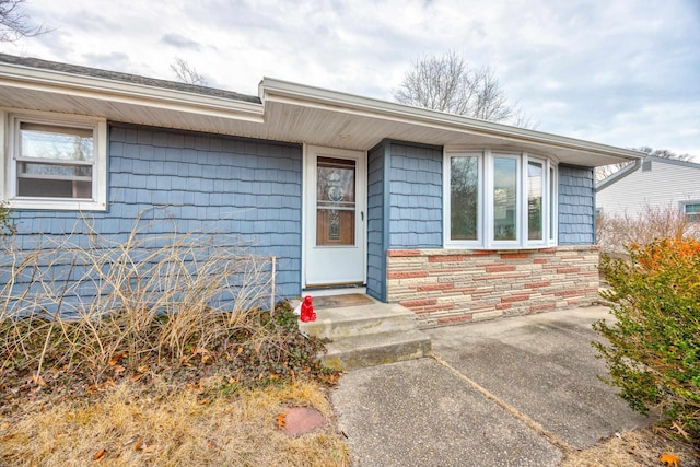 entrance to property with stone siding