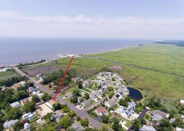 birds eye view of property featuring a water view and a rural view