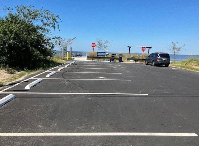 view of parking / parking lot with a water view