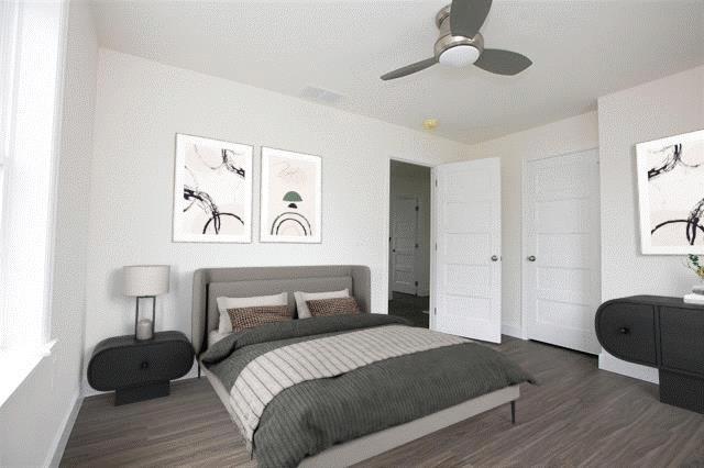 bedroom featuring ceiling fan and dark hardwood / wood-style floors