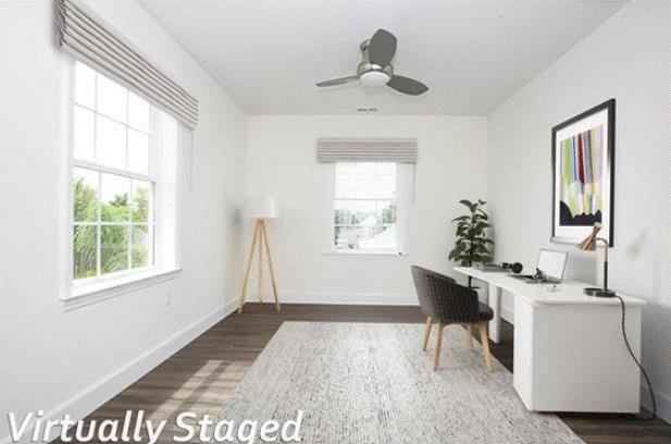 home office with dark hardwood / wood-style floors and ceiling fan