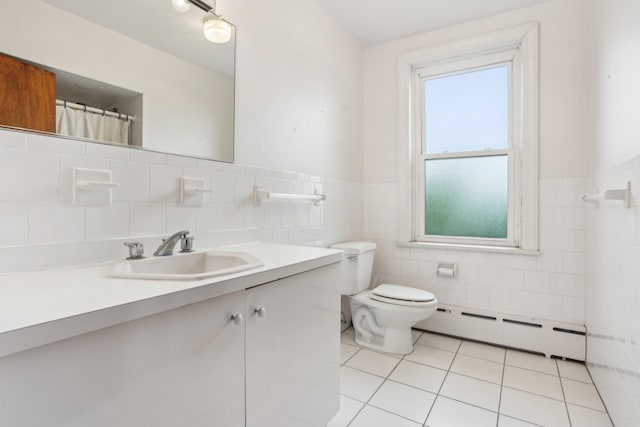 102 S Derby Ave, Ventnor, NJ 08406 - full bath featuring a baseboard radiator, tile walls, plenty of natural light, vanity, and tile patterned flooring