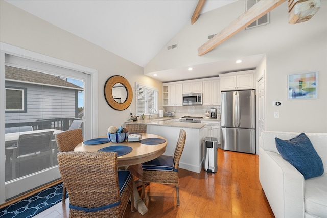 13 93rd St Unit 5, Stone Harbor, NJ 08247 - dining area with light wood-type flooring, beam ceiling, high vaulted ceiling, and recessed lighting