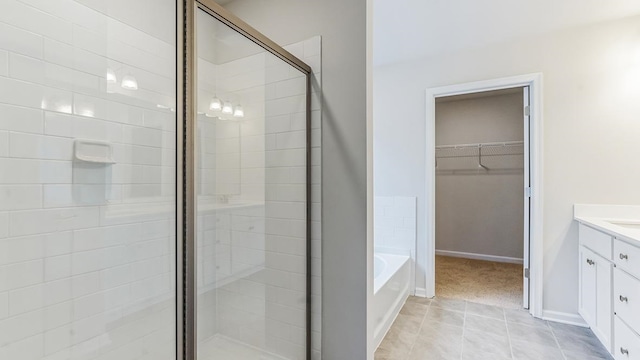 bathroom featuring separate shower and tub, tile patterned flooring, and vanity