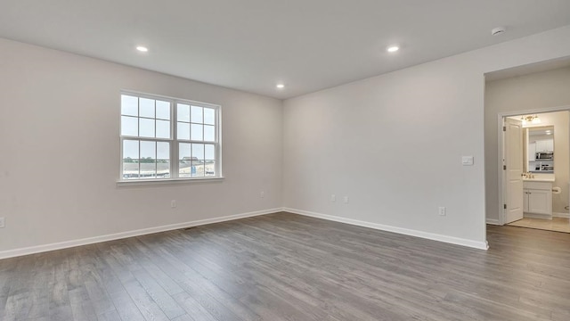 spare room with hardwood / wood-style flooring