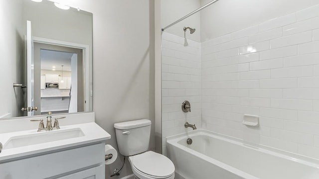 full bathroom featuring toilet, vanity, and tiled shower / bath combo