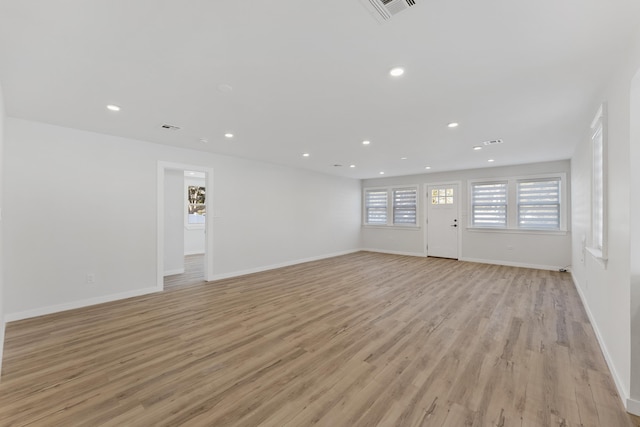 unfurnished living room featuring light wood-type flooring