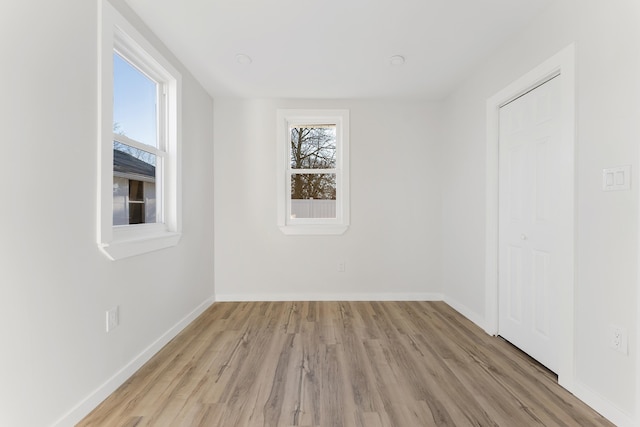 empty room with light hardwood / wood-style floors