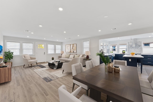 dining area with sink and light wood-type flooring