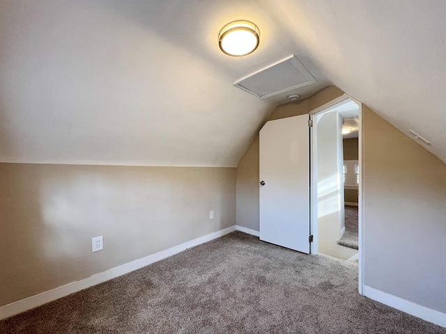 additional living space with carpet floors and vaulted ceiling