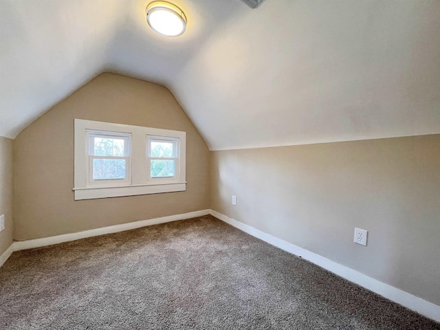 bonus room with carpet floors and vaulted ceiling