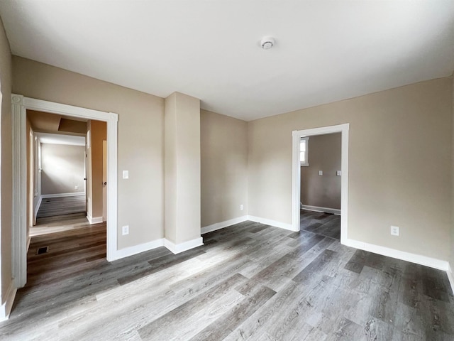 spare room featuring wood-type flooring