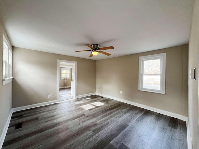 spare room featuring dark wood-type flooring and ceiling fan