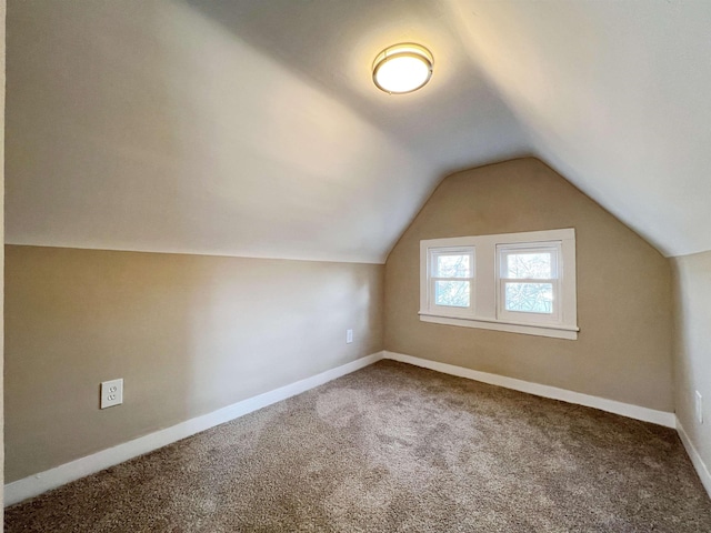 bonus room featuring carpet floors and vaulted ceiling