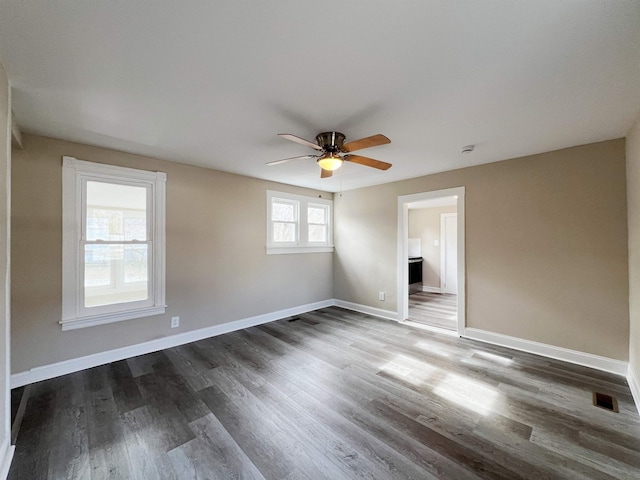 empty room with hardwood / wood-style floors and ceiling fan