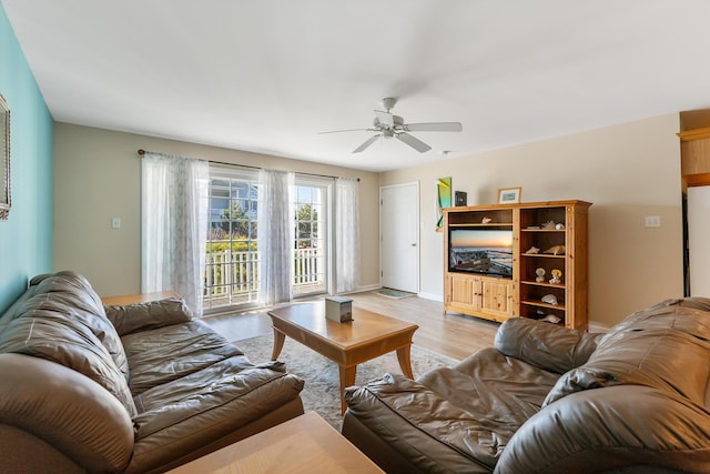 living room featuring light hardwood / wood-style floors and ceiling fan