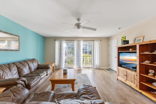 living room featuring ceiling fan and light hardwood / wood-style floors