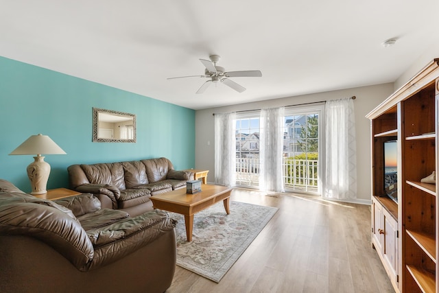 living room featuring ceiling fan and light hardwood / wood-style floors