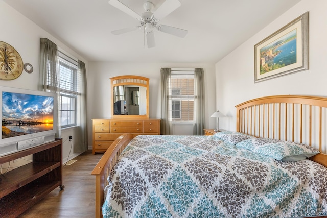 bedroom with ceiling fan and dark hardwood / wood-style flooring