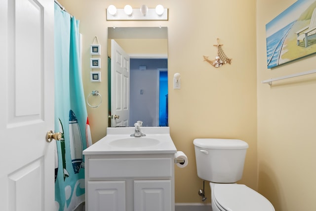 bathroom featuring toilet and vanity