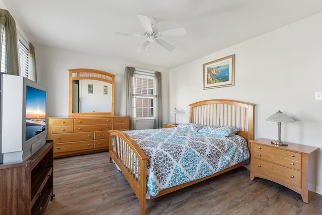 bedroom featuring ceiling fan and dark wood-type flooring