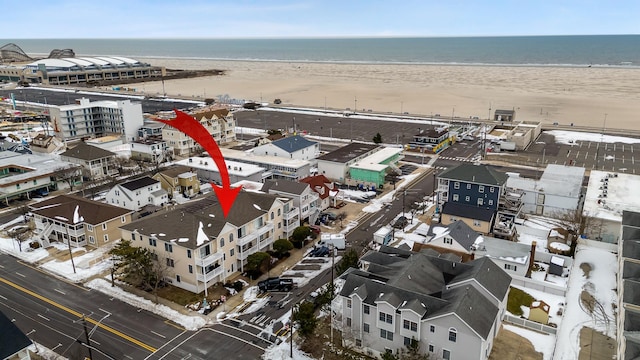 drone / aerial view featuring a view of the beach and a water view