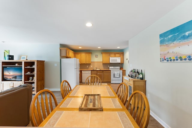 dining space with light wood-type flooring