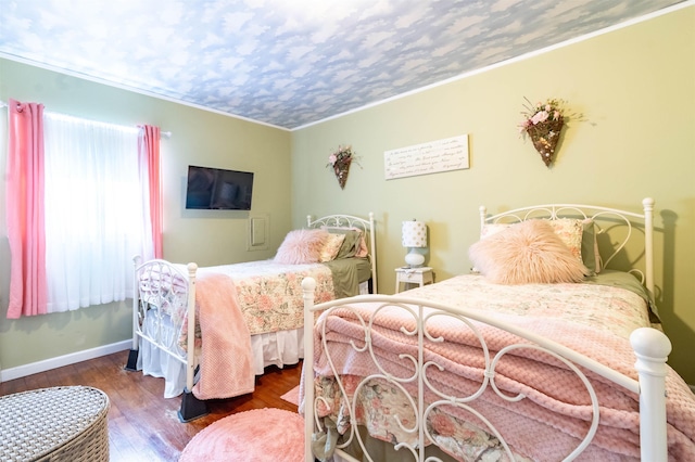 bedroom featuring crown molding and hardwood / wood-style flooring