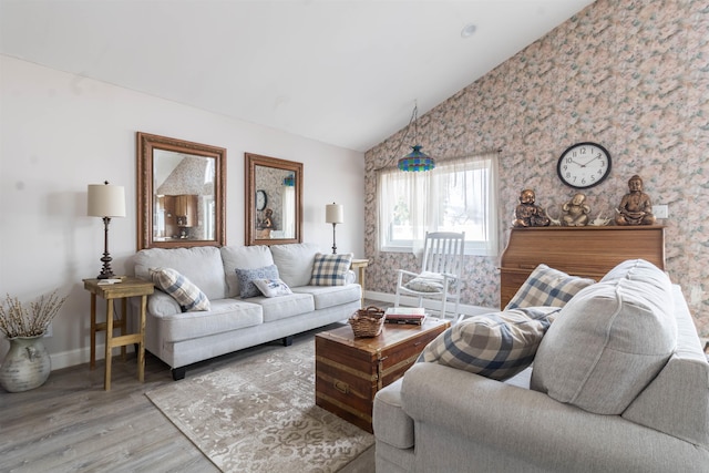 living room featuring vaulted ceiling and hardwood / wood-style floors