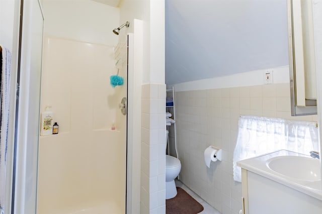 bathroom featuring walk in shower, vanity, and tile walls