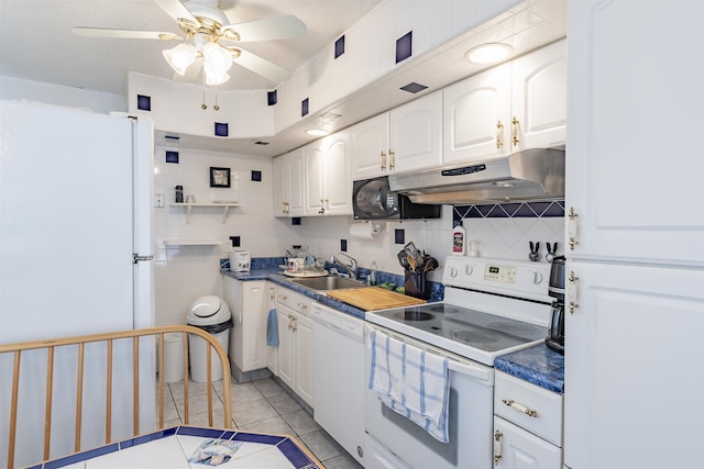 kitchen featuring light tile patterned floors, white cabinetry, decorative backsplash, white appliances, and sink