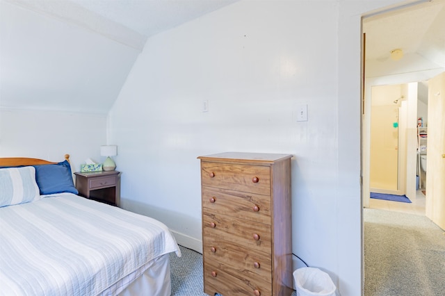 bedroom featuring carpet floors and lofted ceiling