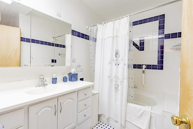 bathroom with decorative backsplash, shower / bathtub combination with curtain, and vanity