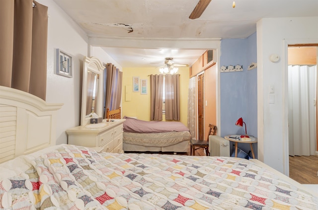 bedroom featuring ceiling fan and radiator