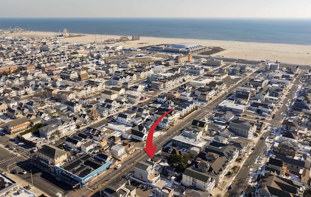 bird's eye view featuring a water view and a view of the beach